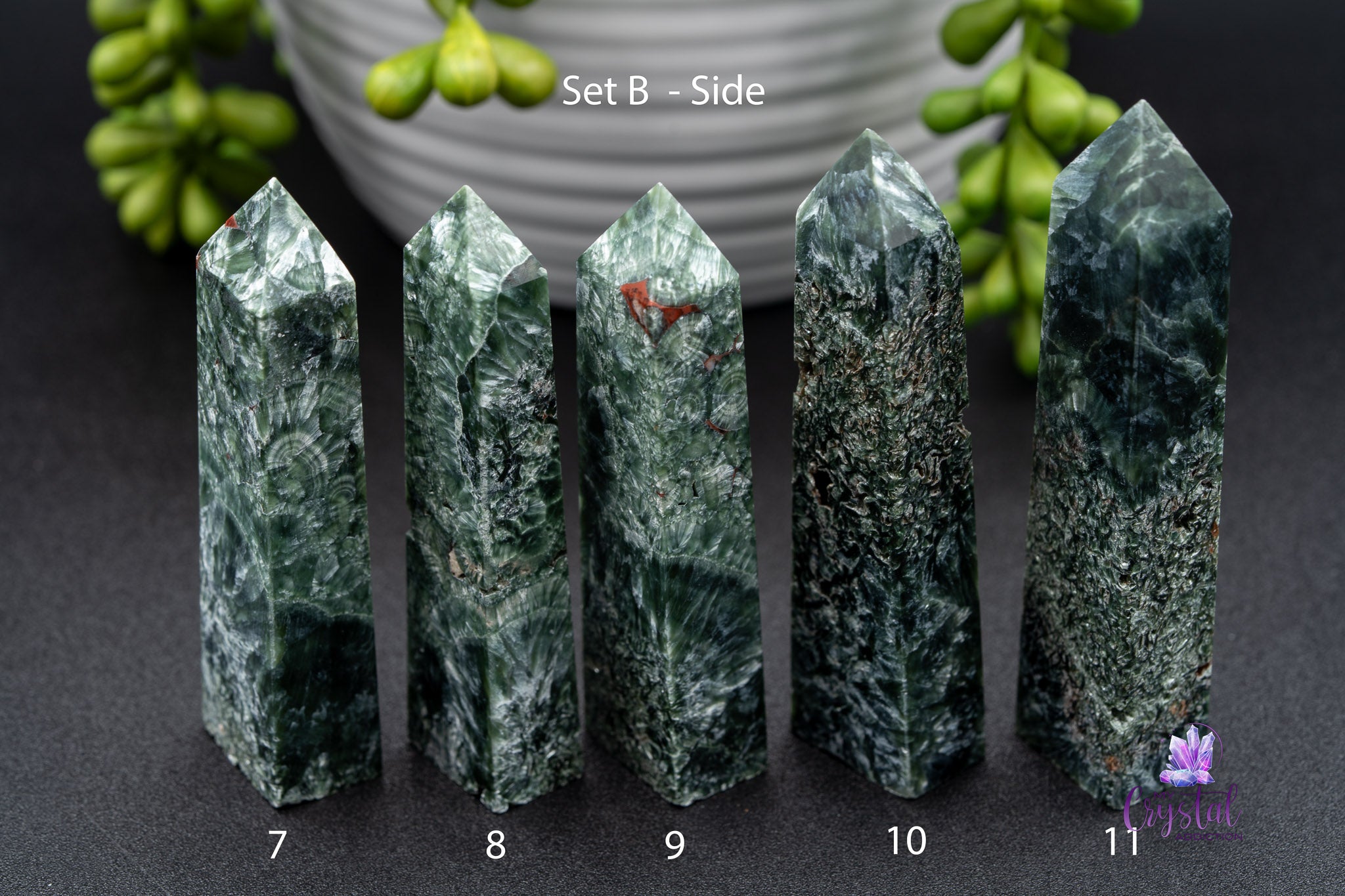 Set B side view of five green kambaba jasper crystal towers numbered 7 to 11, on black surface