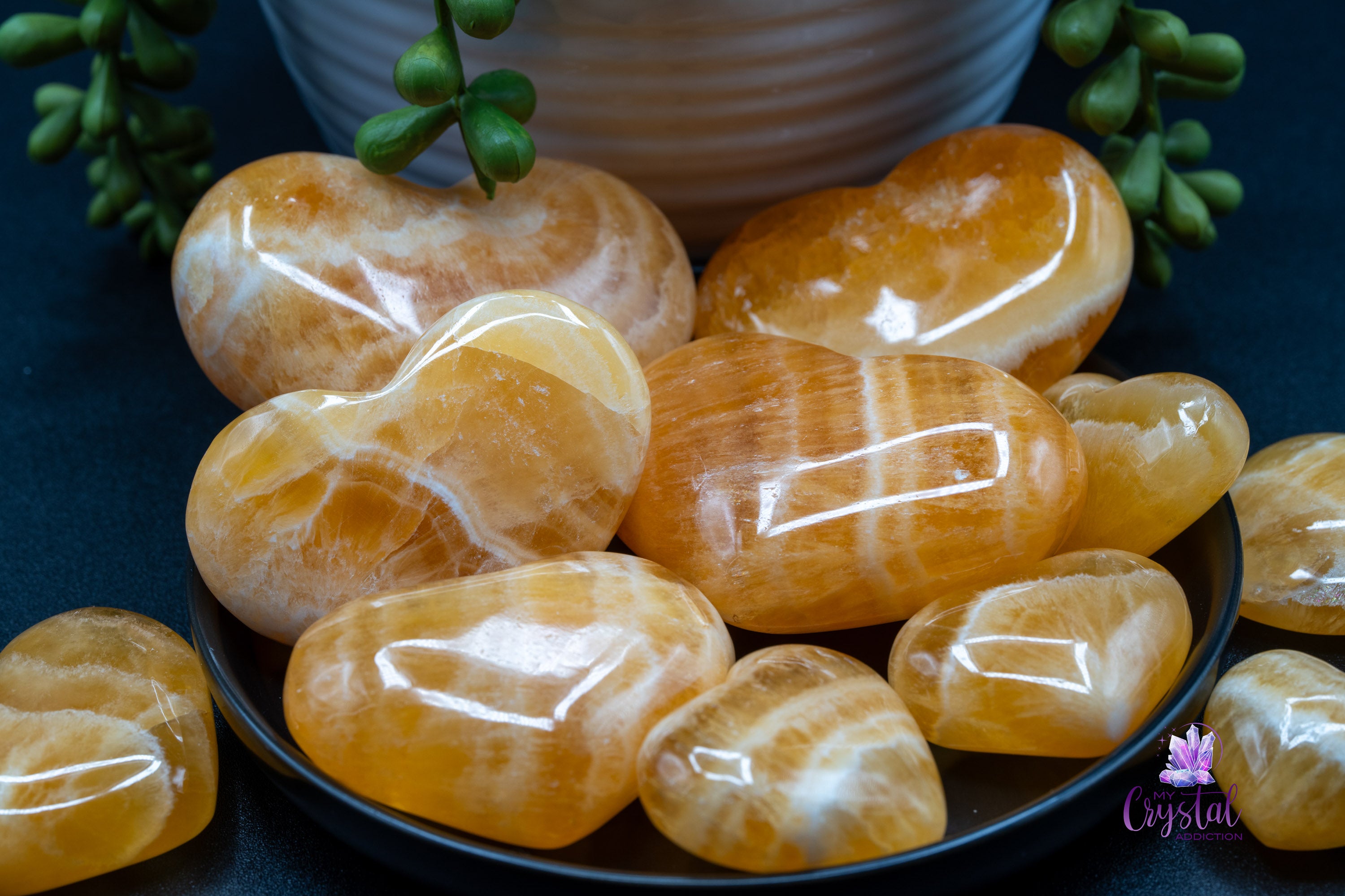 Polished orange calcite heart carvings
