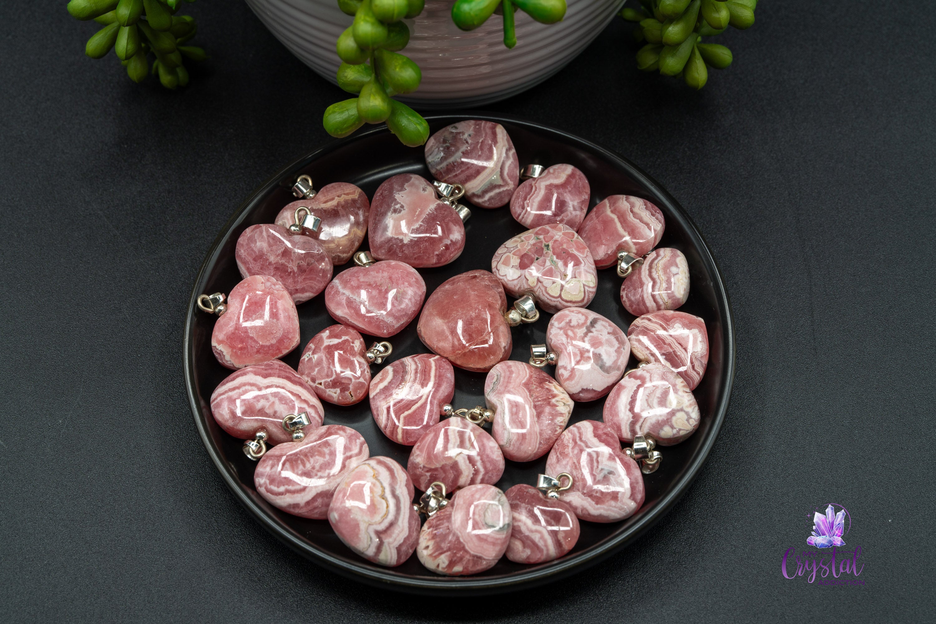 Close-up of polished rhodochrosite heart pendants