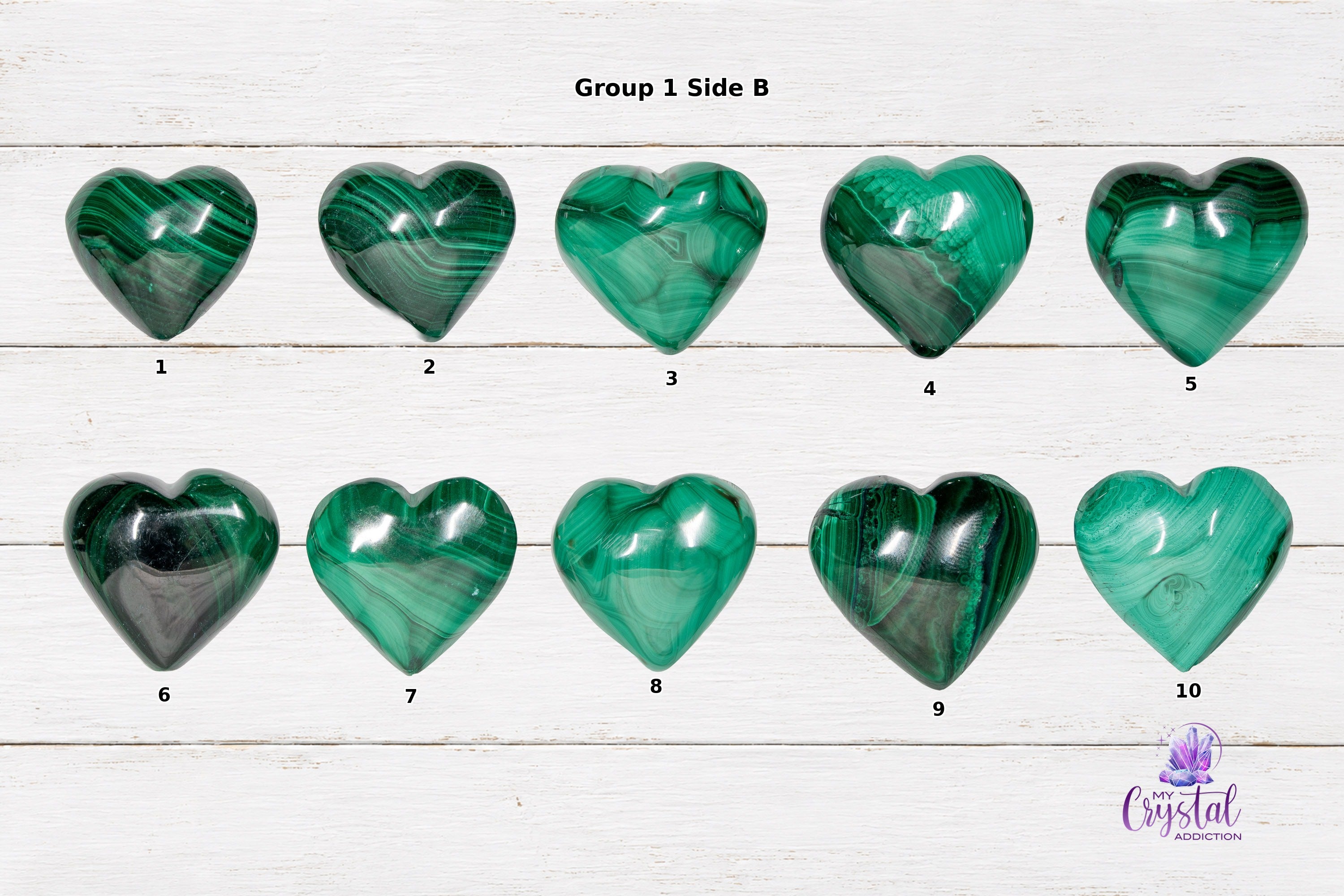 Alternate-side views of polished malachite heart carvings arranged on white wood.